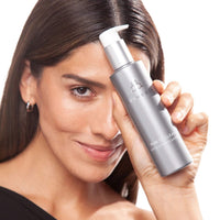 COSMEDIX Purity Clean Hydrating Cleanser in a sleek, metallic silver pump bottle with a white dispenser cap, shown against a plain white background. at skin type solutions with model