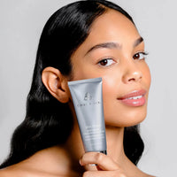 Cosmedix Skin Thirst Moisturizing Hyaluronic Acid Cream in a metallic silver squeeze tube with a reflective cap, shown on a plain white background. at skin type solutions with model