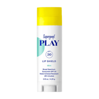 A single stick of SuperGoo! PLAY Lip Shield sunscreen with SPF 30 in Coconut scent, featuring a white body with blue text and a bright yellow cap, set against a plain white background. Skin type solutions mint