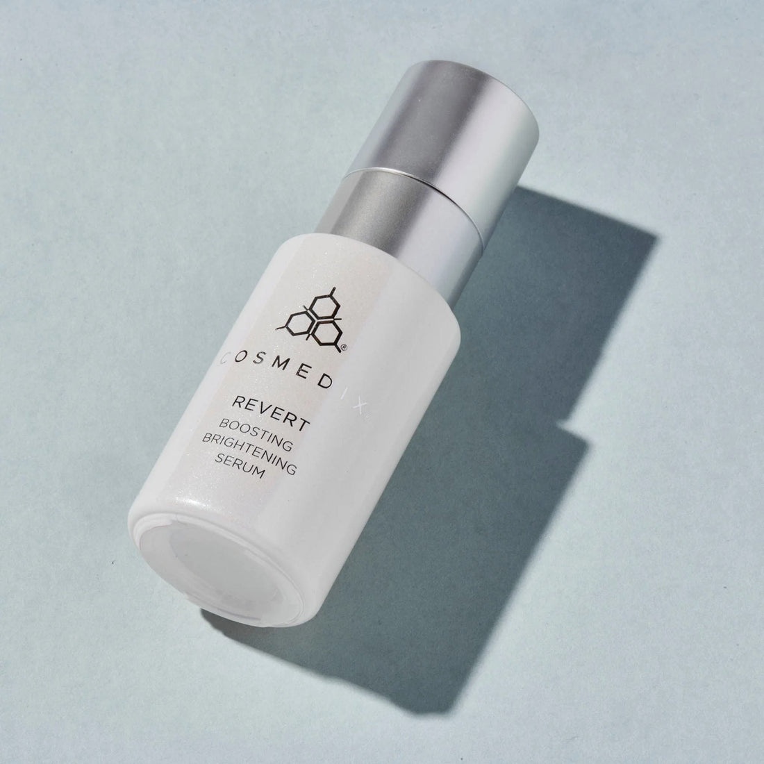 Cosmedix Revert Boosting Brightening Serum bottle on a blue background at skin type solutions