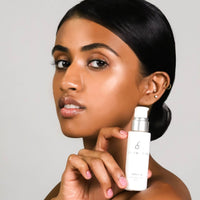 COSMEDIX Serum 16 Rapid Renewal Serum in a frosted white cylindrical bottle with a silver pump dispenser and white cap, shown on a plain white background. Skin Type Solutions with model