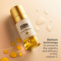 ISDIN ISOCHEUTICS FLAVO-C ADVANCED skincare serum bottle with a gold cap and white label, set on a beige background with golden droplets and text describing biphasic technology. Skin type solutions