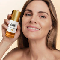 ISDIN ISDINCEUTICS FLAVO-C ADVANCED skincare serum bottle with a white body, gold cap, and golden liquid visible in the clear base, on a white background. Skin type solutions with model